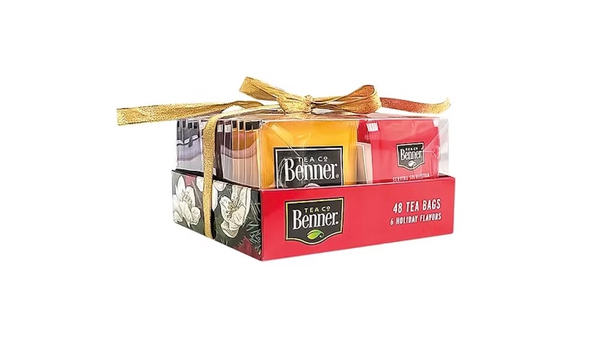 A boxed tea gift set labeled "Benner Tea Co," containing 48 tea bags in six holiday flavors. The box is wrapped with a gold ribbon tied in a bow.