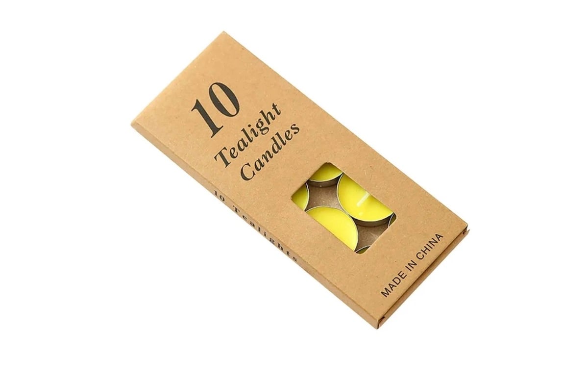 A brown cardboard box labeled "10 Tealight Candles" with a small window showing yellow candles inside. The box also has "MADE IN CHINA" printed on the bottom right corner.