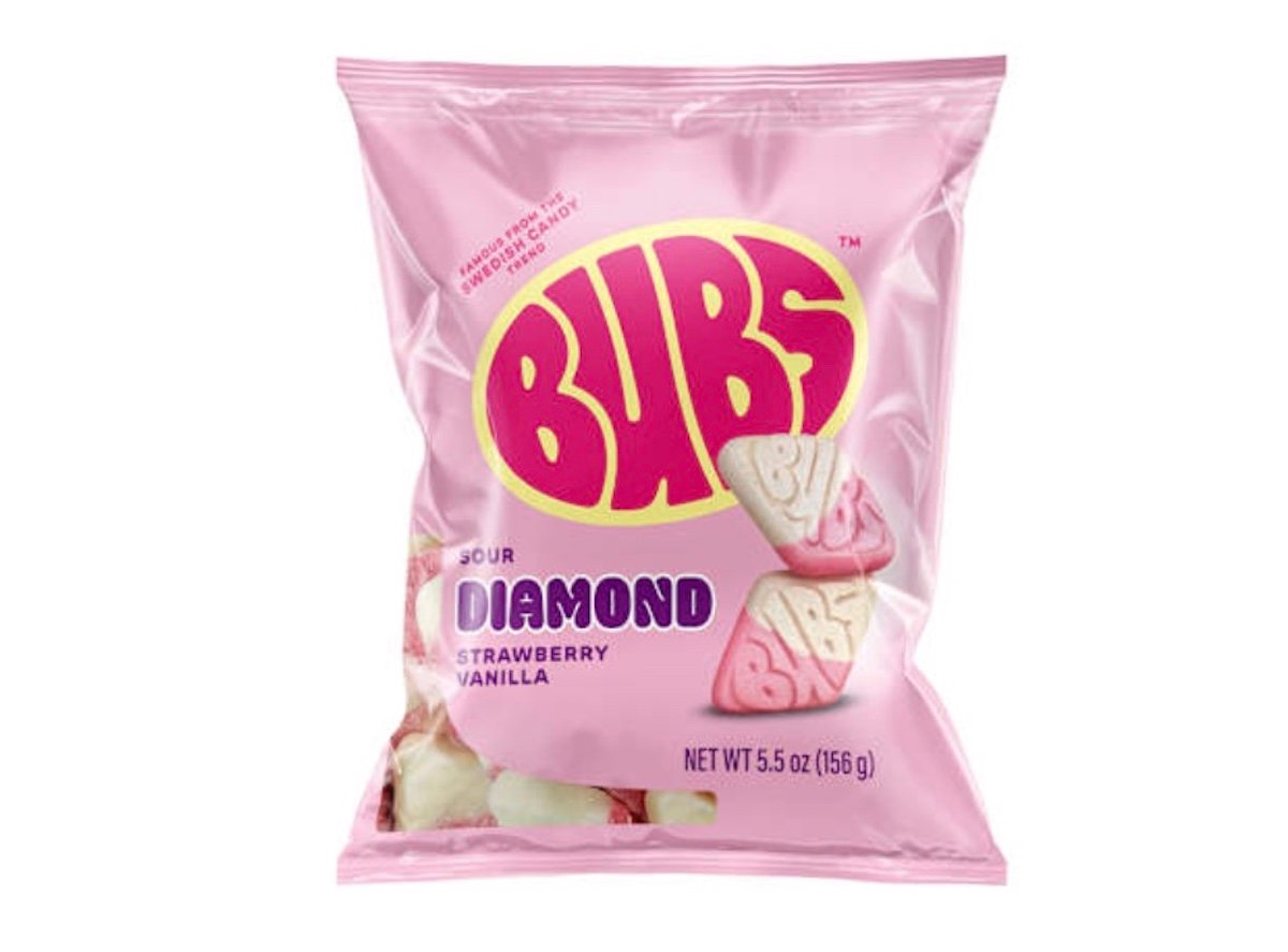 A pink bag of Bubs Sour Diamond Strawberry Vanilla candy shows images of pink and white diamond-shaped gummies with "BUBS" embossed on them. The bag weighs 5.5 oz (156 g).