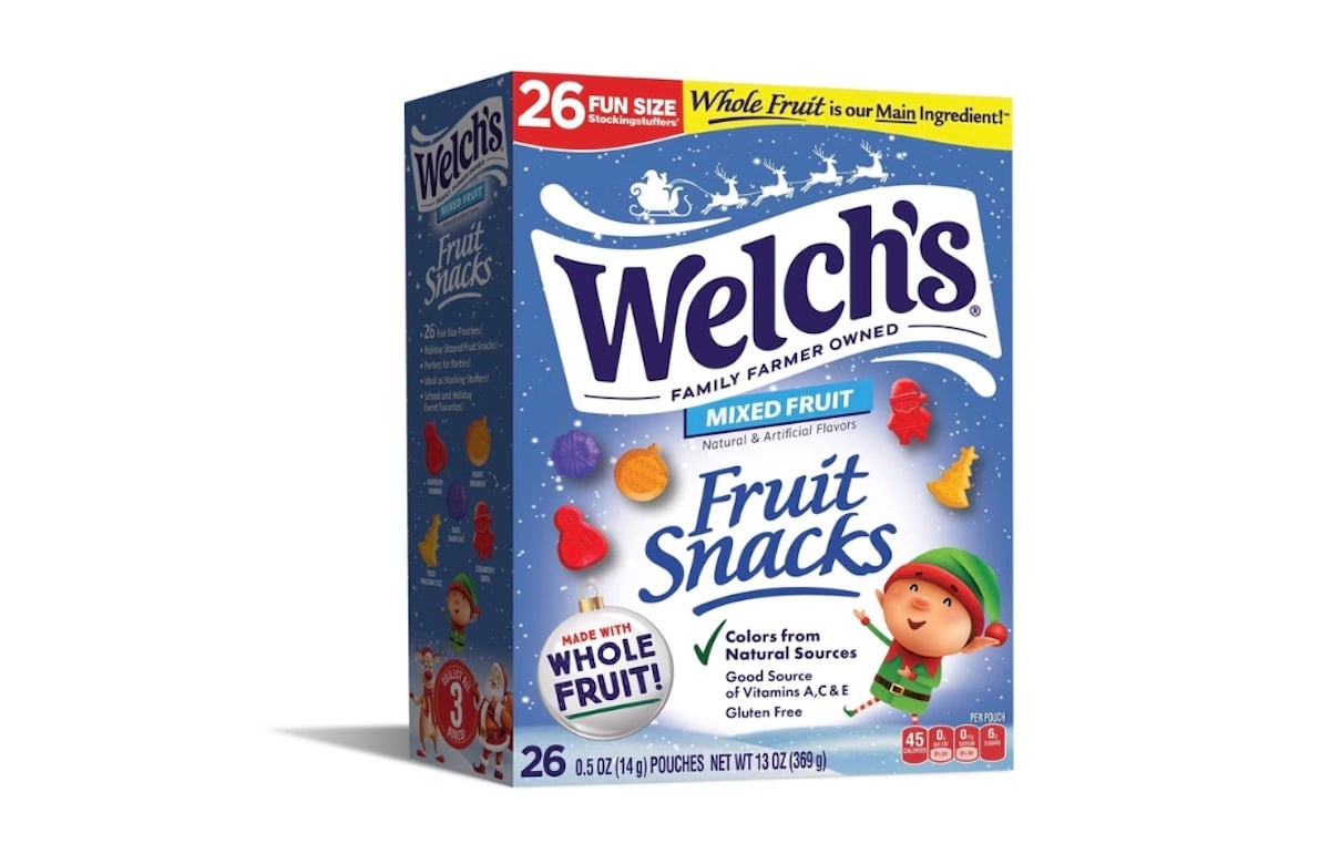 A box of Welch’s Mixed Fruit Fruit Snacks featuring colorful fruit images, a smiling elf cartoon, and labels highlighting “whole fruit,” “gluten free,” and “26 pouches” on the front of the packaging.