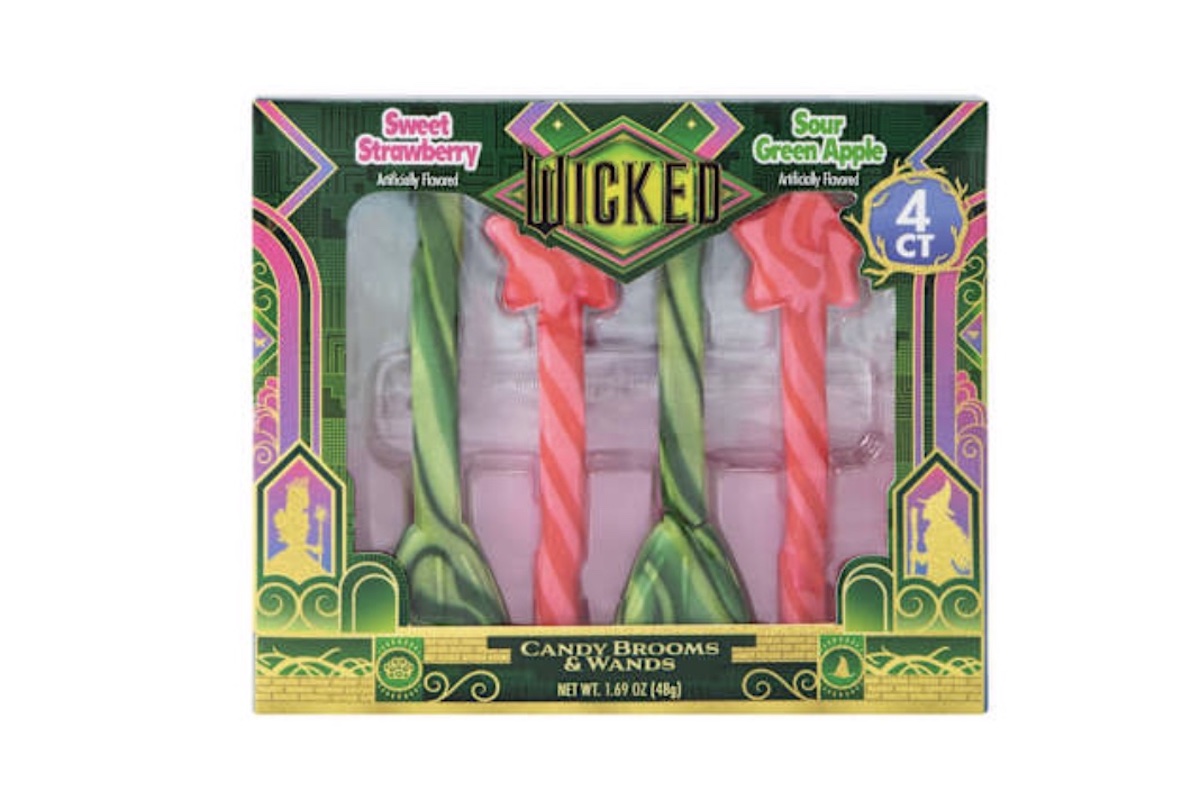 A box of "Wicked" candy brooms and wands featuring four striped candies—two pink (sweet strawberry flavor) and two green (sour green apple flavor)—in a decorative, colorful package.