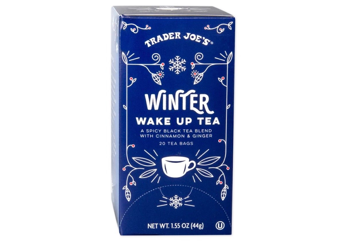 A blue box of Trader Joe’s Winter Wake Up Tea, featuring white text and illustrations of snowflakes and a steaming teacup. The tea is a spicy black tea blend with cinnamon and ginger, containing 20 tea bags.