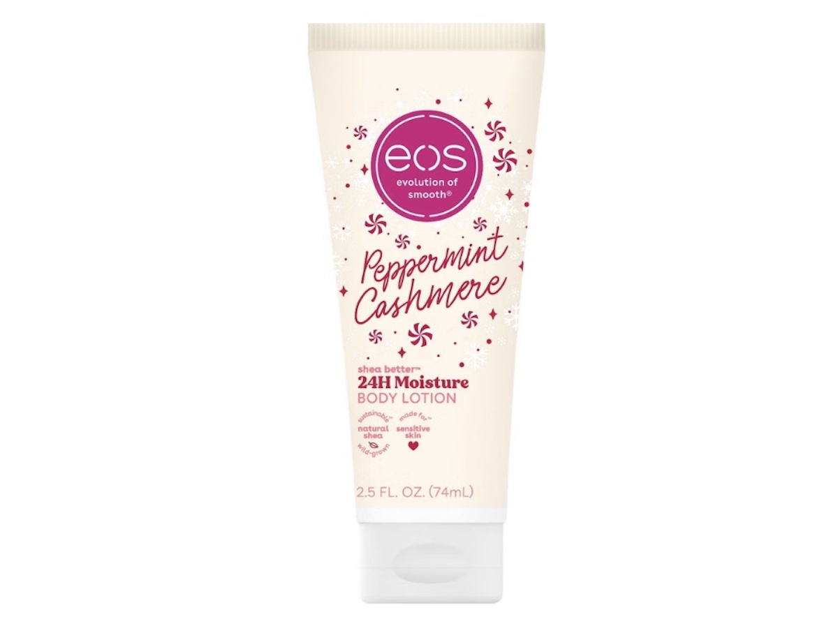 A tube of eos Peppermint Cashmere 24H Moisture Body Lotion with shea butter, featuring pink and red text and small peppermint candy illustrations on a beige background. The tube is 2.5 fl oz (74mL).