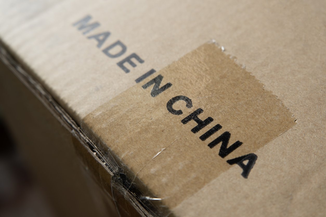 A close-up of a cardboard box with the words "MADE IN CHINA" printed in bold black letters on the surface.