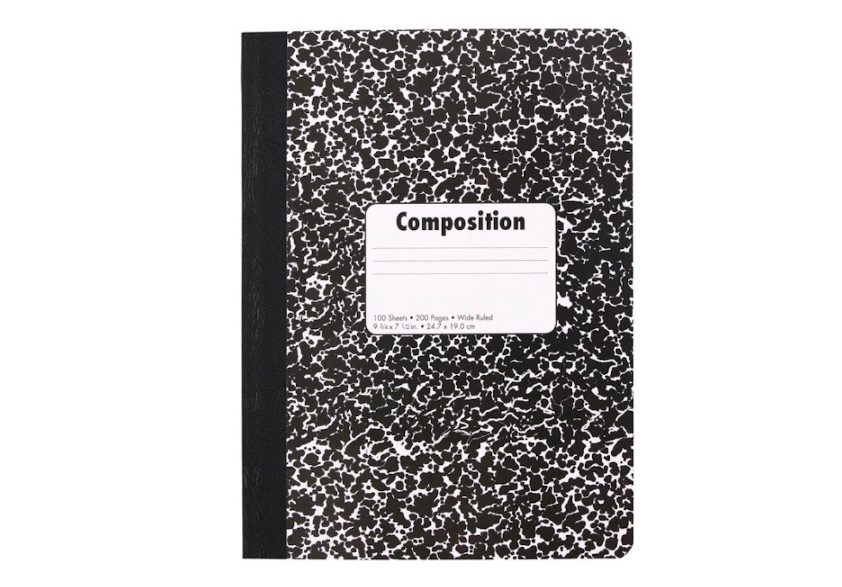 A black and white marbled composition notebook with a black spine and a white label on the front cover for writing a name or subject.