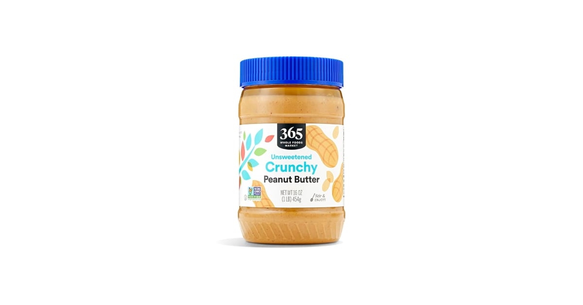 A jar of 365 Whole Foods Market Unsweetened Crunchy Peanut Butter with a blue lid and a white label featuring peanut illustrations, against a plain white background.