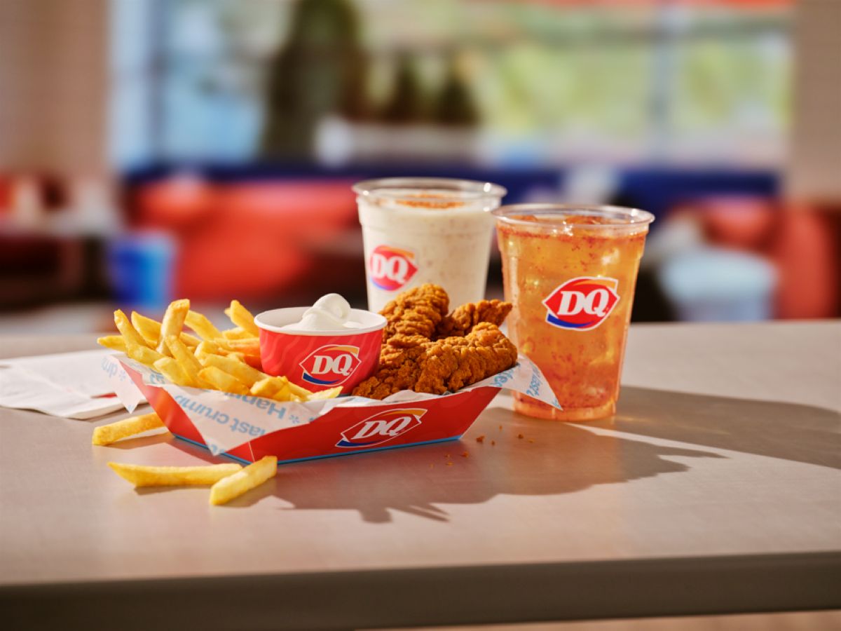 A Dairy Queen meal from the new fast-food menu features crispy chicken strips, French fries, dipping sauce, a milkshake, and a soft drink—all served in branded Dairy Queen containers on a table.