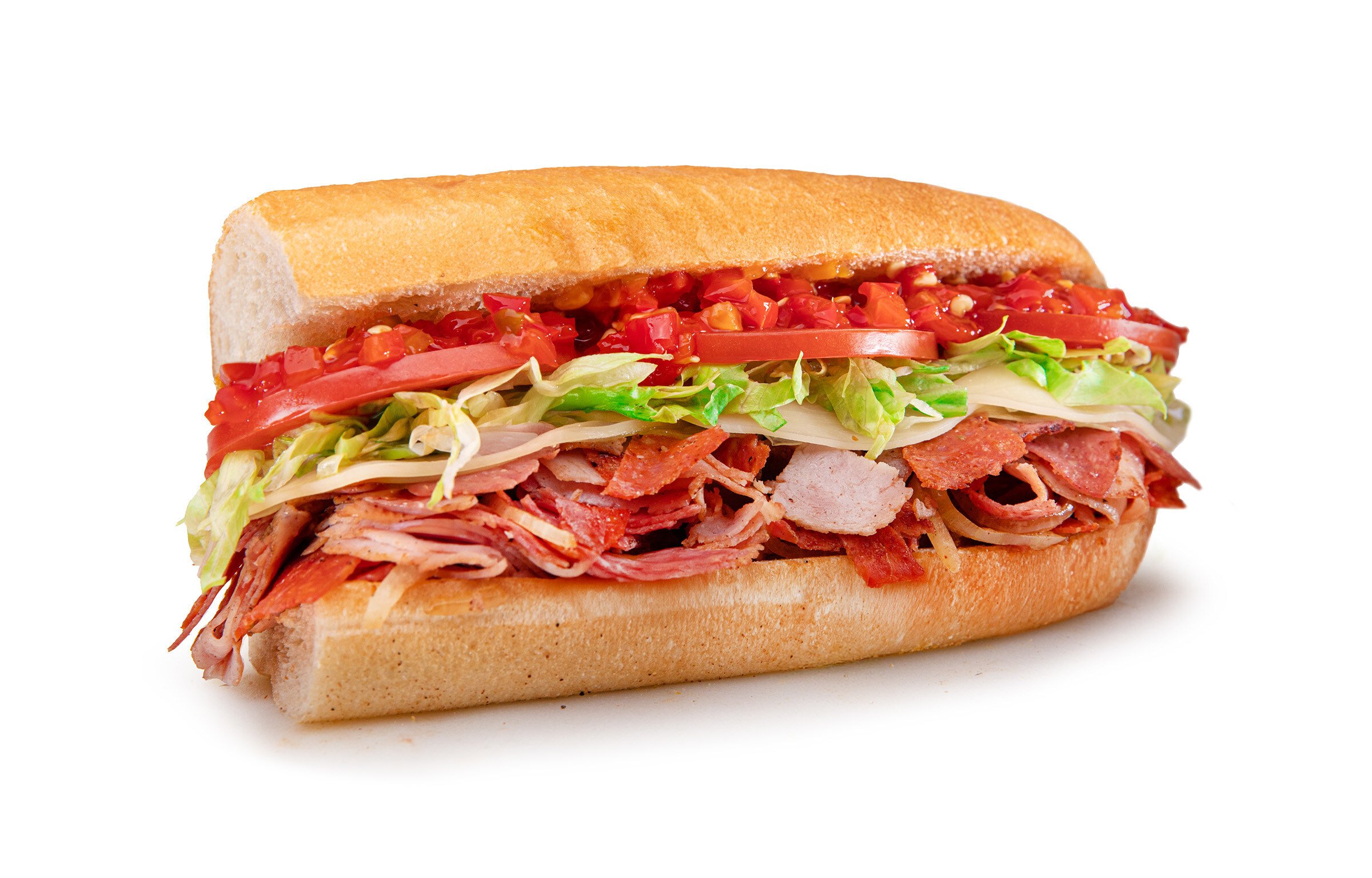 A sub sandwich from the new fast-food menu on white bread, piled with sliced meats, shredded lettuce, tomato slices, diced tomatoes, and cheese, all set against a clean white background.