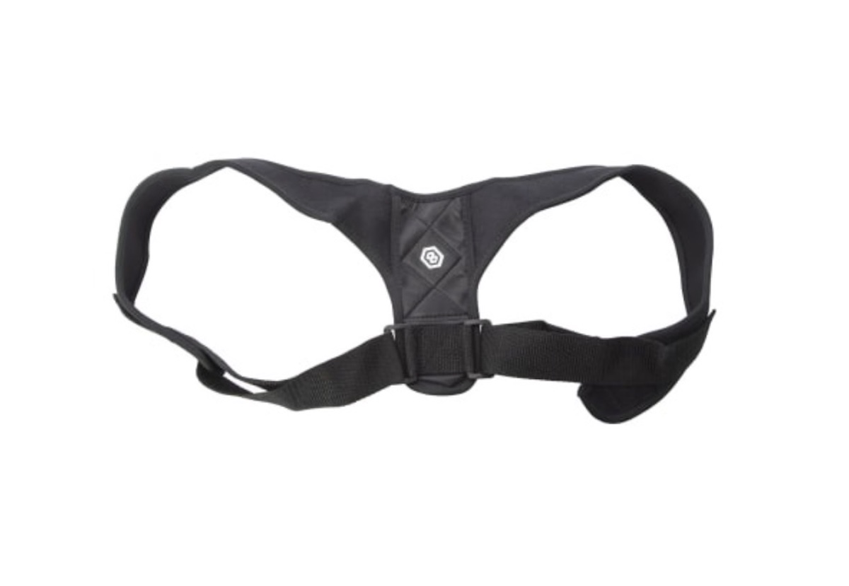 A black adjustable posture corrector strap with a central padded section and two shoulder loops, designed to be worn on the upper back.