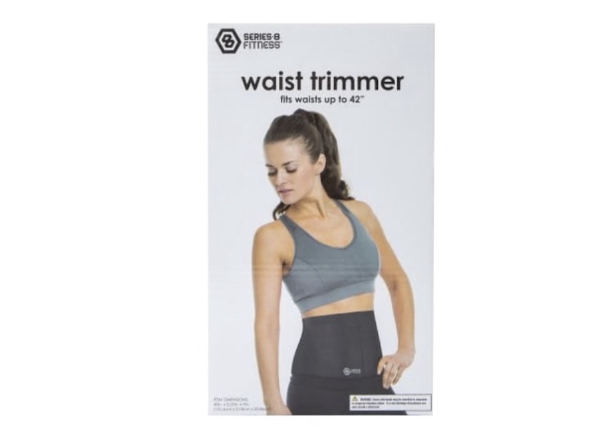 A woman wearing a gray sports bra and a black waist trimmer stands against a light background. The text above reads, "waist trimmer fits waists up to 42" with the Series 8 Fitness logo in the top left corner.