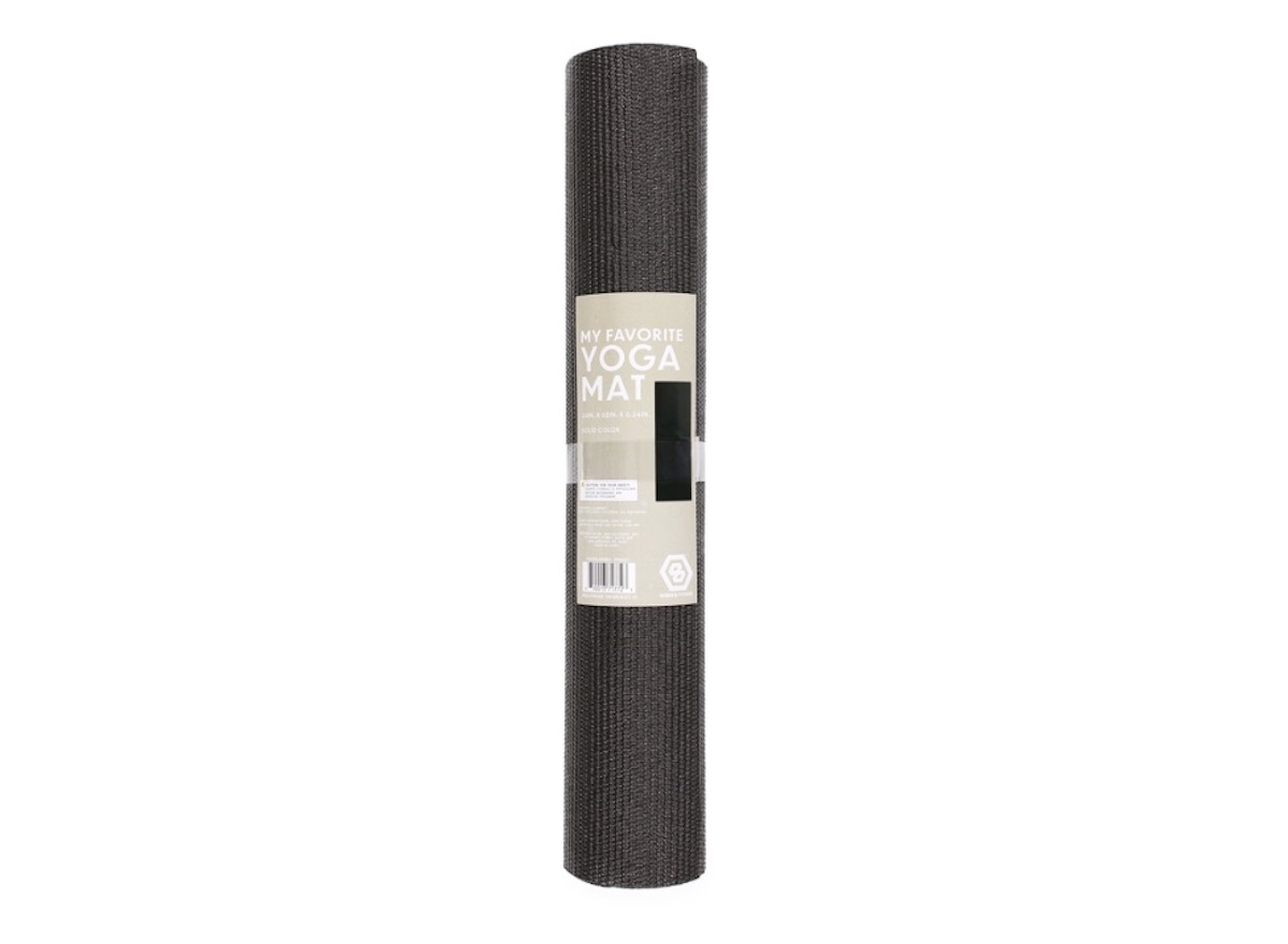 A rolled-up black yoga mat with a beige label that reads "My Favorite Yoga Mat" standing upright on a white background.