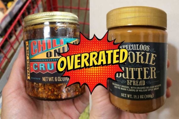 A split image of overrated Trader Joe&rsquo;s Chili Onion Crunch and Speculoos Cookie Butter jars, with a bright comic-style &ldquo;OVERRATED&rdquo; graphic in the center.