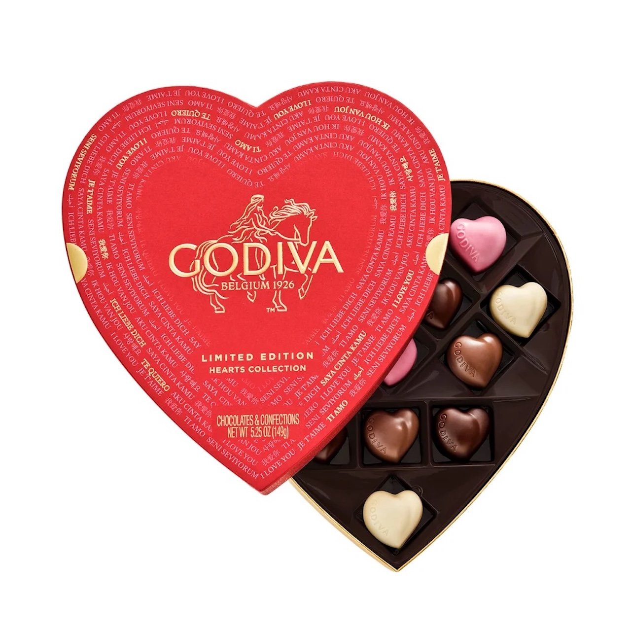 A red, heart-shaped Godiva chocolate box with gold lettering is partially open, revealing an assortment of heart-shaped chocolates in various shades of brown, pink, and white inside.