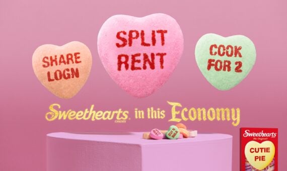 Three candy hearts on a pink background read &ldquo;SHARE LOGIN,&rdquo; &ldquo;SPLIT RENT,&rdquo; and &ldquo;COOK FOR 2.&rdquo; Below, yellow text says &ldquo;Sweethearts in this Economy.&rdquo; A box of Sweethearts candy appears in the bottom right corner.