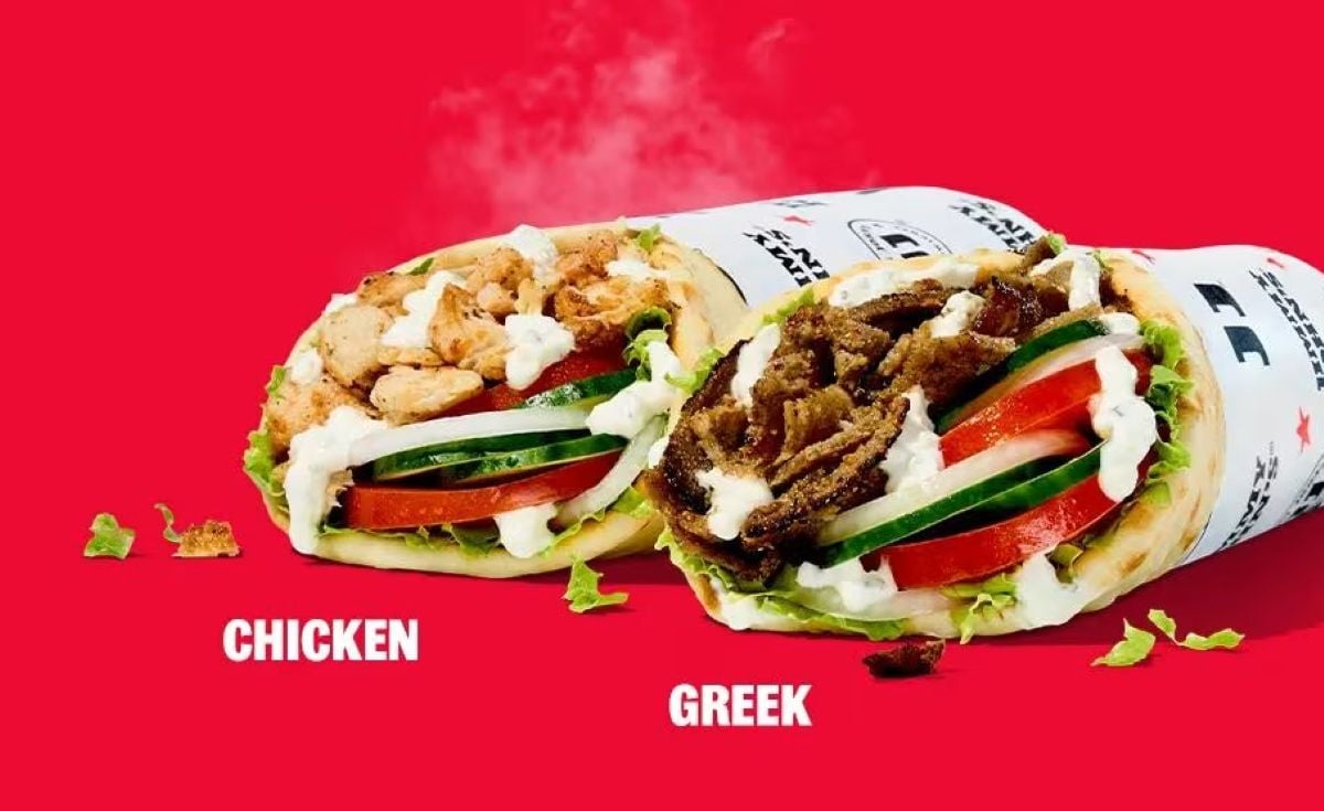 Two wraps from the new fast-food menu on a red background—one with grilled chicken, the other with sliced gyro meat. Each wrap is filled with lettuce, tomato, cucumber, and white sauce, labeled “CHICKEN” and “GREEK.”