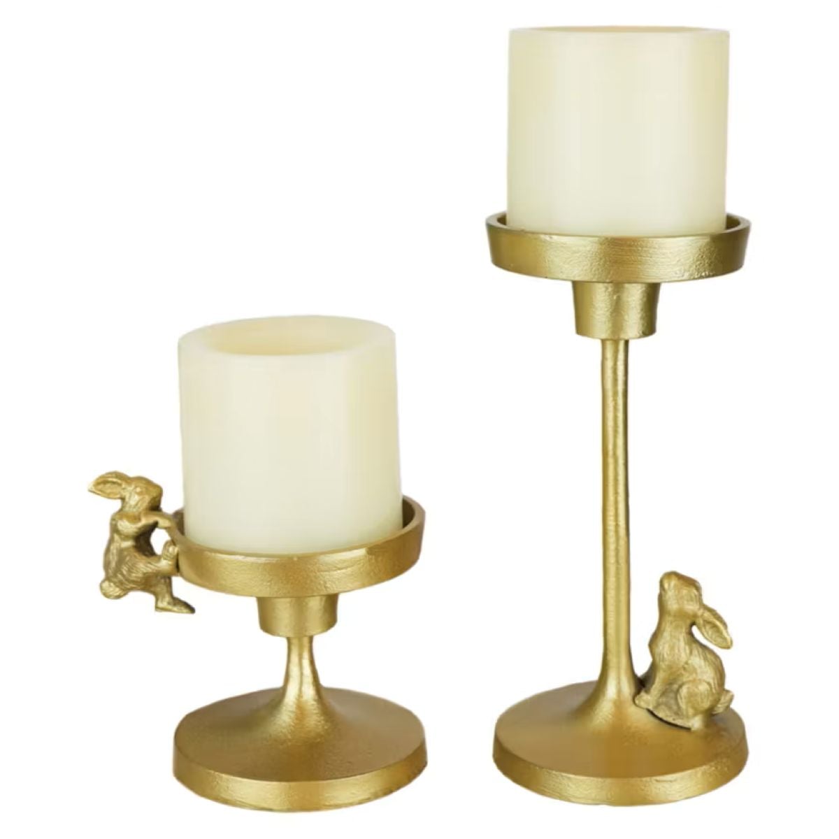 Two gold candle holders with cream-colored pillar candles. One holder is short with a small rabbit figurine climbing the side, and the other is taller with a rabbit figurine sitting at the base.