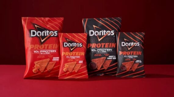 Four Doritos protein chips bags are displayed against a red background, featuring Nacho Cheese and Sweet & Tangy BBQ flavors with 10g or 17g of protein per serving. The red and black packaging boasts bold text and an eye-catching design.