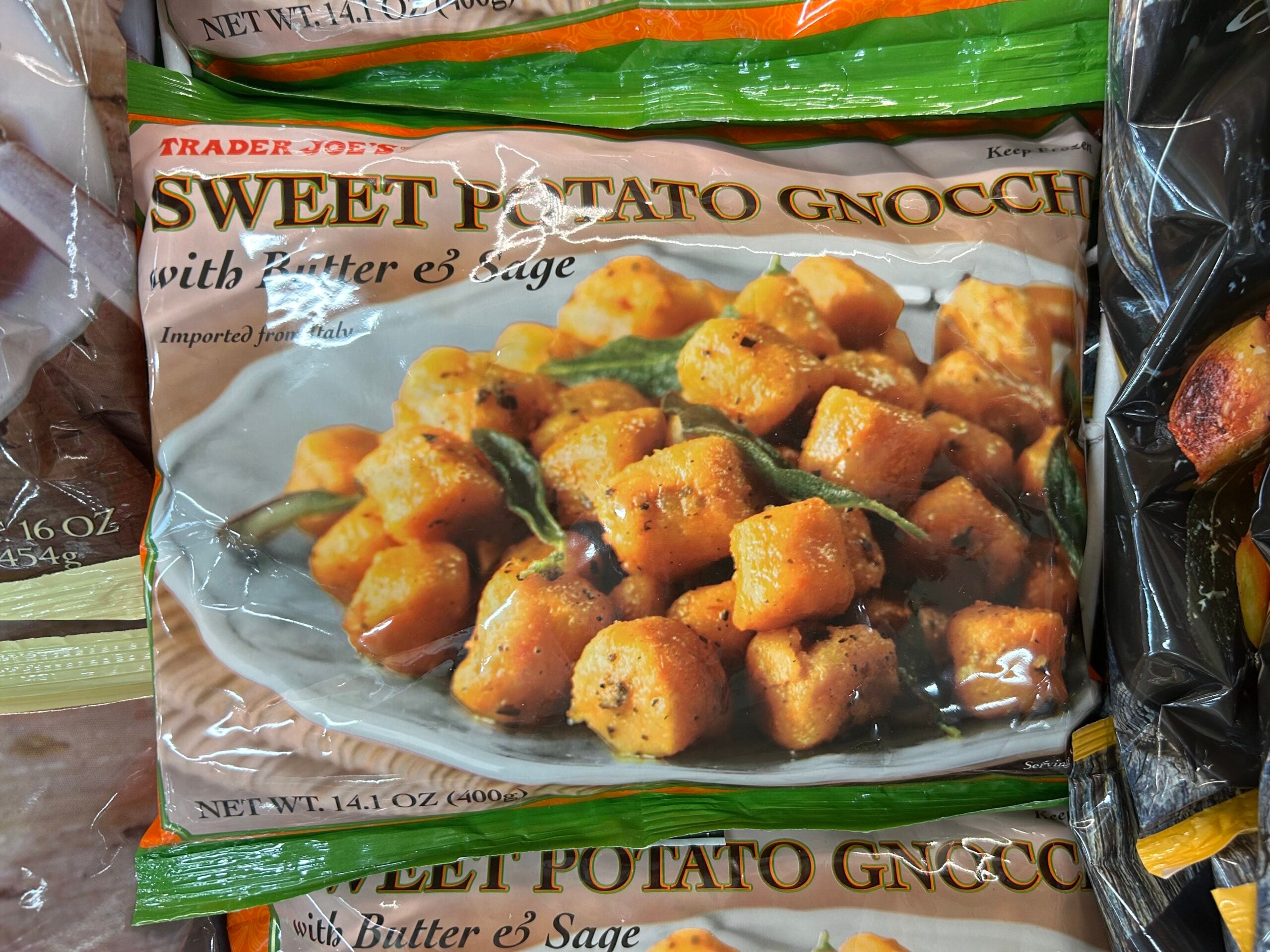 A bag of Trader Joe’s Sweet Potato Gnocchi with Butter & Sage shows an image of golden-brown gnocchi garnished with sage on the front of the packaging.