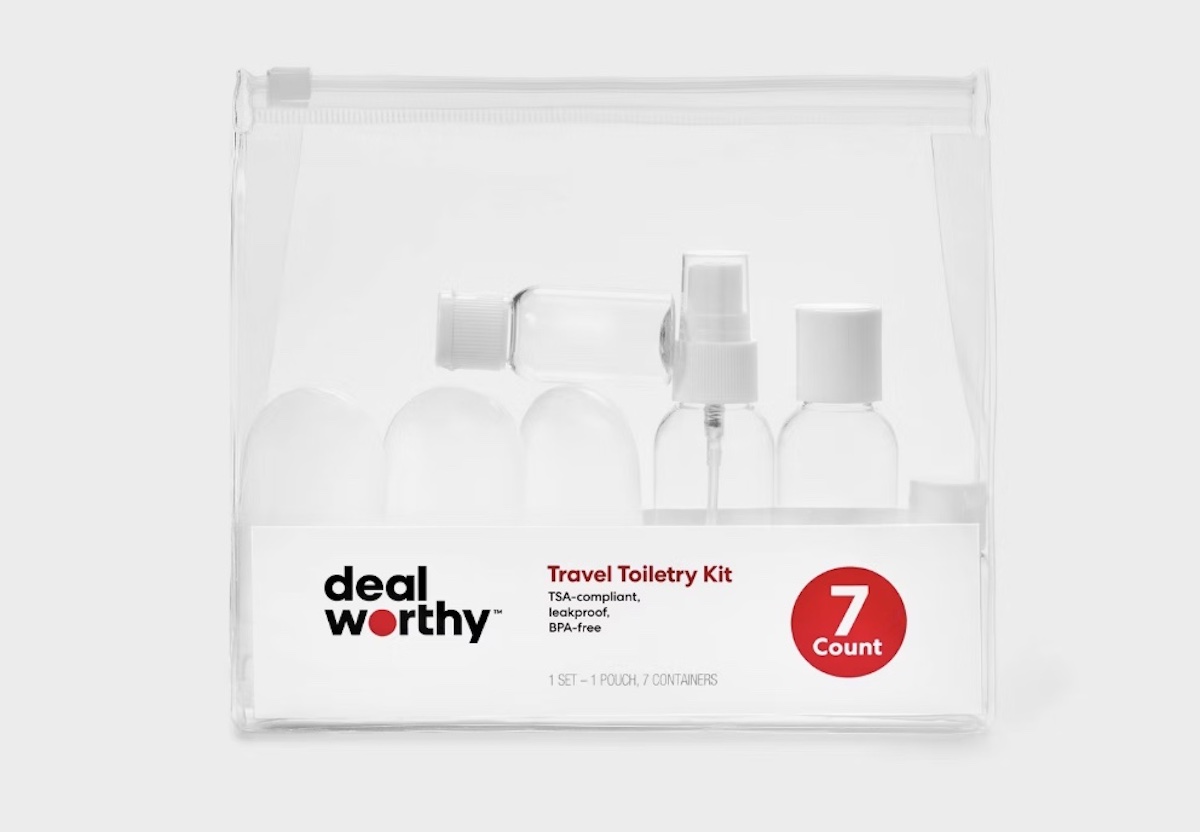 A clear plastic travel toiletry kit, perfect for spring break, containing seven empty refillable bottles and containers with a white and red label reading "deal worthy," "Travel Toiletry Kit," and "7 Count.