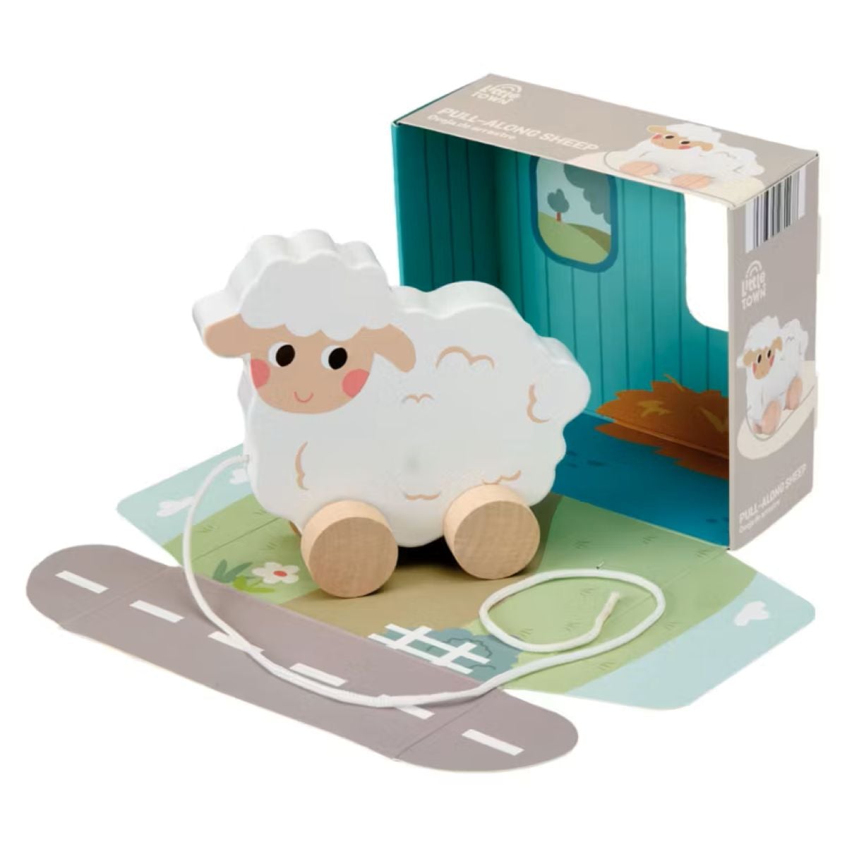 A wooden pull-along sheep toy with wheels and a string, placed on a play mat with a road. The toy’s packaging, decorated with sheep illustrations and a farm scene, is shown in the background.
