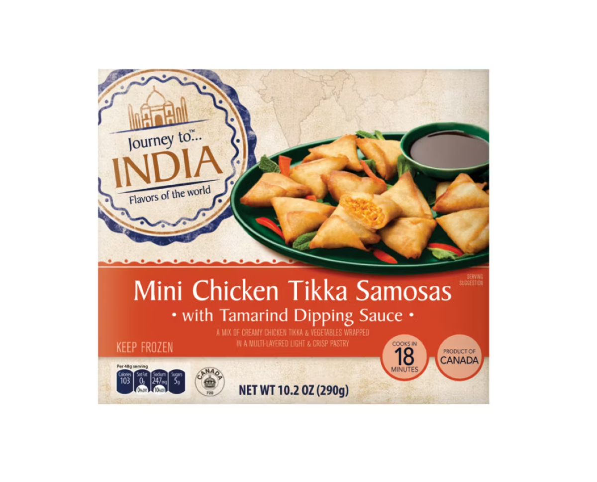 A box of "Journey to India Mini Chicken Tikka Samosas with Tamarind Dipping Sauce" shows samosas on a green plate with dipping sauce. The packaging states "keep frozen" and "product of Canada.