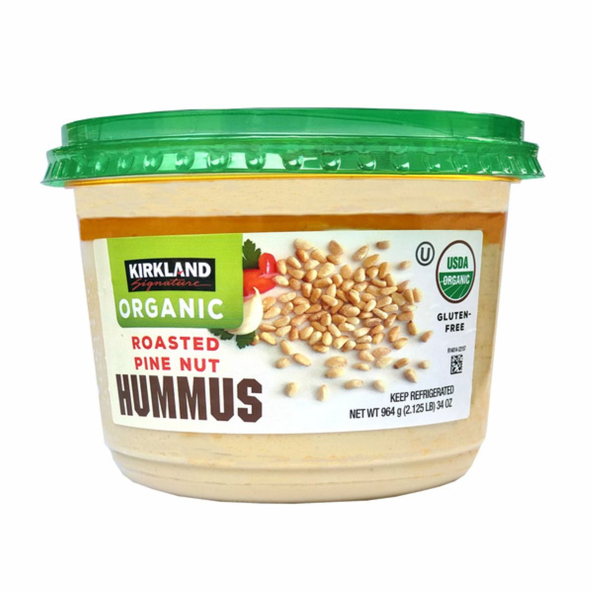 A container of Kirkland Signature Organic Roasted Pine Nut Hummus with a green lid, displaying images of pine nuts and labels for USDA Organic and Gluten-Free.