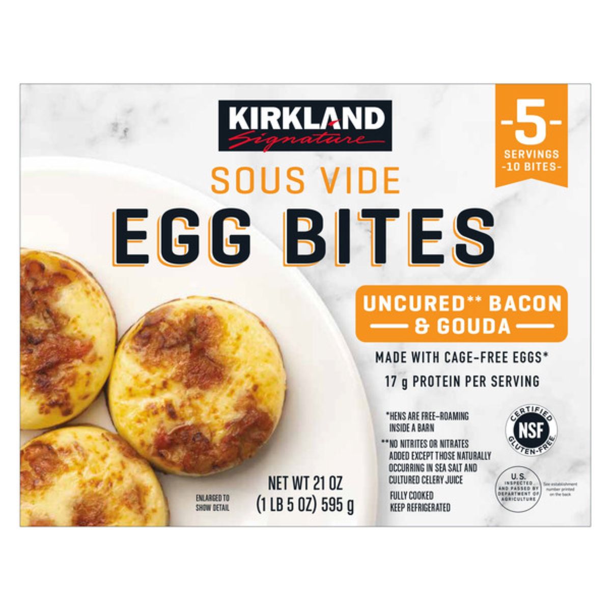 Kirkland Signature Sous Vide Egg Bites box showing three egg bites with bacon and gouda. The packaging highlights 17g protein per serving, made with cage-free eggs, and is fully cooked and refrigerated.