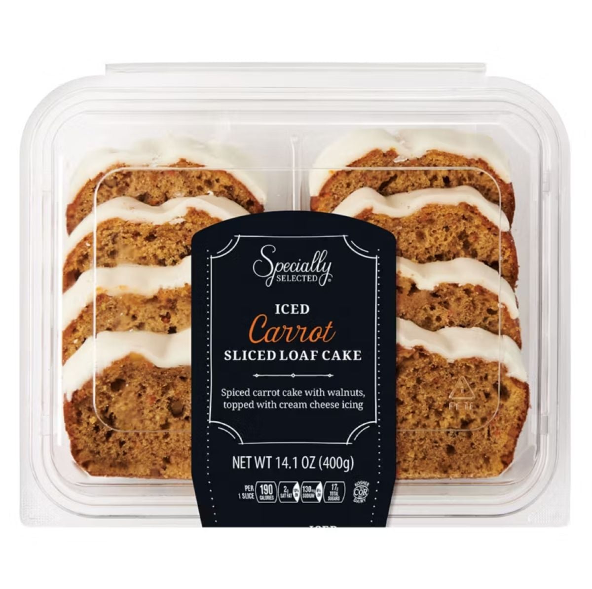 A clear plastic container holds six slices of iced carrot loaf cake with cream cheese icing on top. The black label reads "Specially Selected Iced Carrot Sliced Loaf Cake" and describes the cake as spiced and topped with walnuts.