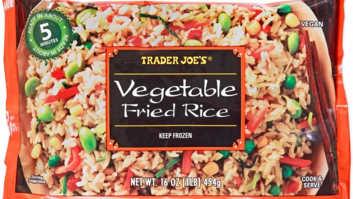 A package of Trader Joe’s Vegetable Fried Rice, featuring rice mixed with carrots, peas, and edamame. The vegan 16 oz (454g) offering is ready in about 5 minutes—check for any fried rice recall updates on the packaging.
