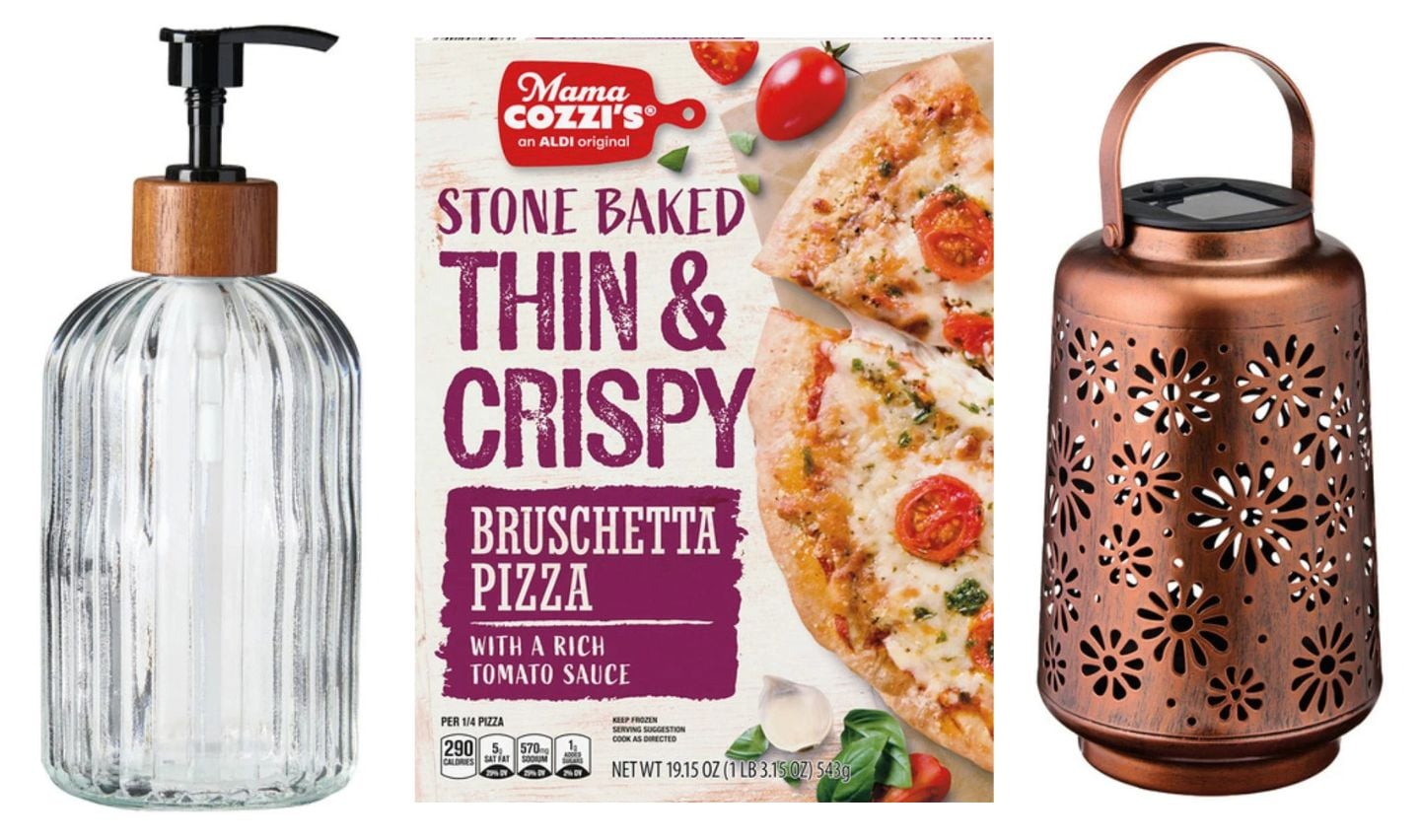 A glass soap dispenser with a black pump, a box of Mama Cozzi’s Stone Baked Thin & Crispy Bruschetta Pizza—one of the new Aldi products April 8—and a decorative bronze lantern with a floral cutout design sit side by side against a white background.