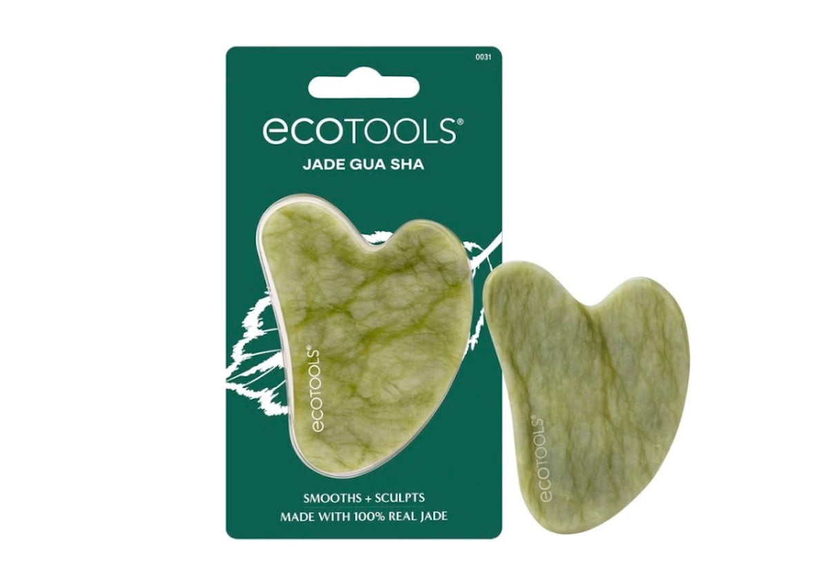 A green jade gua sha facial tool by Ecotools, shown both inside its dark green packaging and outside. The packaging reads “100% real jade” and “Smooths + Sculpts,” making it a thoughtful choice for Mother’s Day gifts.