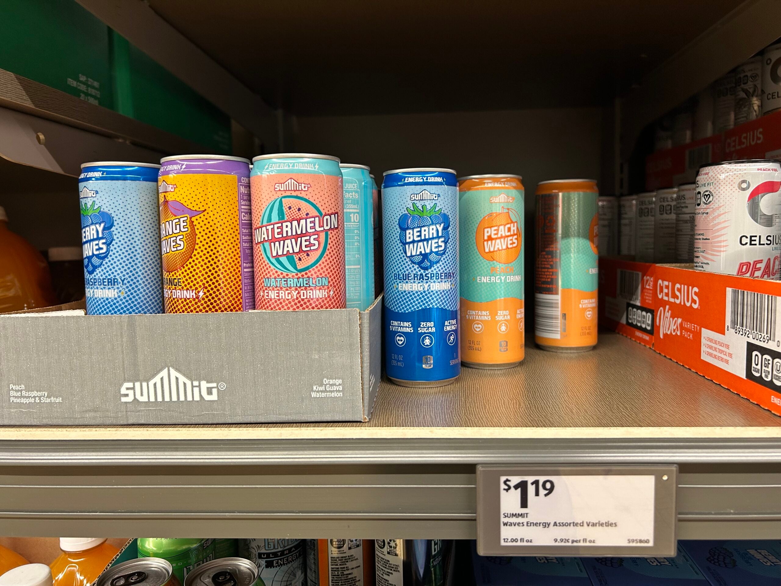 Cans of Summit Energy drinks in flavors like Berry Waves, Watermelon Waves, Orange Waves, and Peach Waves are displayed on a store shelf, with a price tag showing $1.19 each.