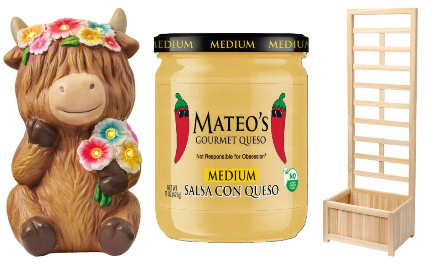 A ceramic cow figurine with flowers, a jar of Mateo’s medium salsa con queso from the new Aldi products April 22 lineup, and a wooden vertical planter are displayed side by side on a white background.