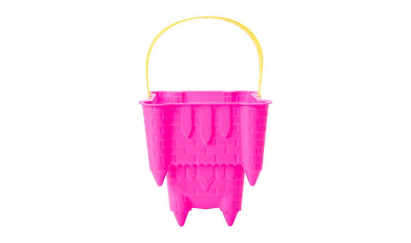 A bright pink plastic sandcastle-shaped bucket with a yellow handle, inspired by new Five Below products, isolated on a white background.