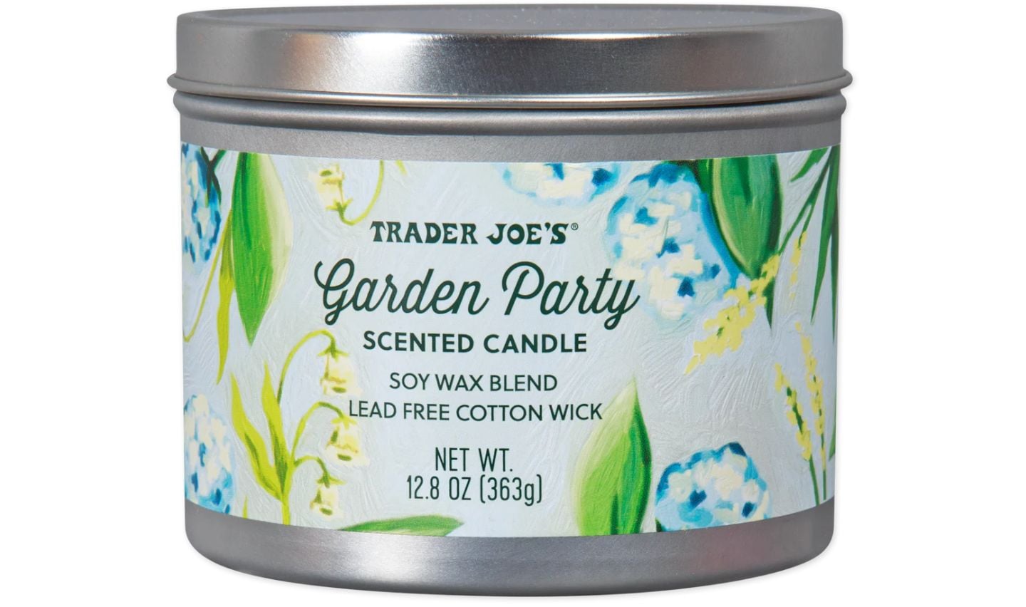 A silver tin of Trader Joe's Garden Party scented candle, perfect for trader joe's mother's day gifts, features a floral design and label noting it’s made from a soy wax blend with a lead-free cotton wick, weighing 12.8 oz (363g).