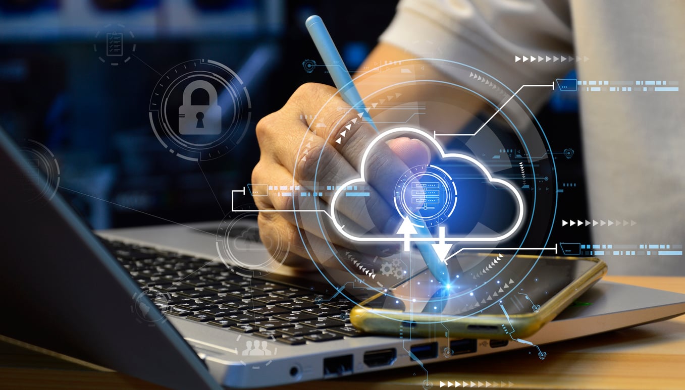 A person using a tablet and stylus on a laptop keyboard, with digital cloud computing graphics and security icons overlayed, symbolizing cloud technology and data protection.