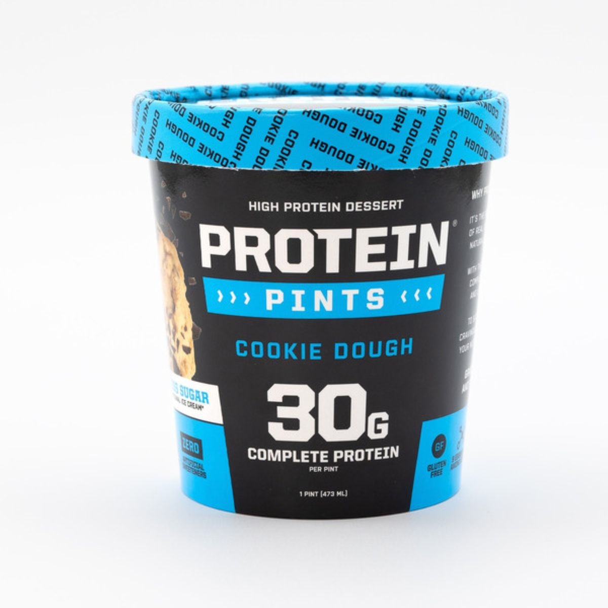 A pint container of Protein Pints Cookie Dough high protein dessert, featuring a blue lid and label. The label highlights “30g complete protein,” “zero added sugar,” and “1 pint (473ml).”