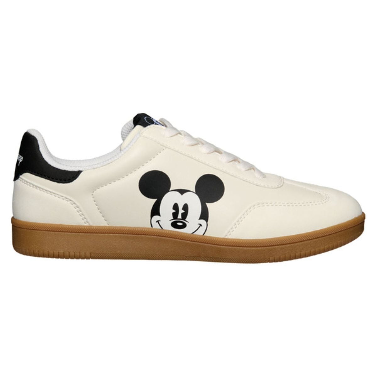 A white sneaker with a brown sole, featuring a large cartoon image of Mickey Mouse’s face on the side and black detailing near the heel.