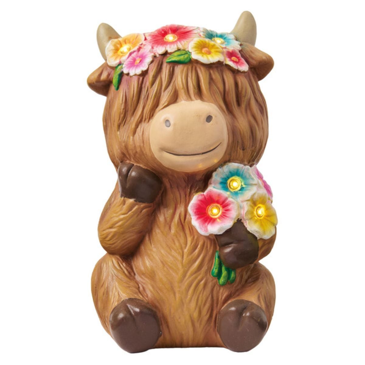 A cute, brown, cartoon-style cow figurine with a flower crown and bouquet, sitting and smiling. Some flowers have small lights that appear to glow.