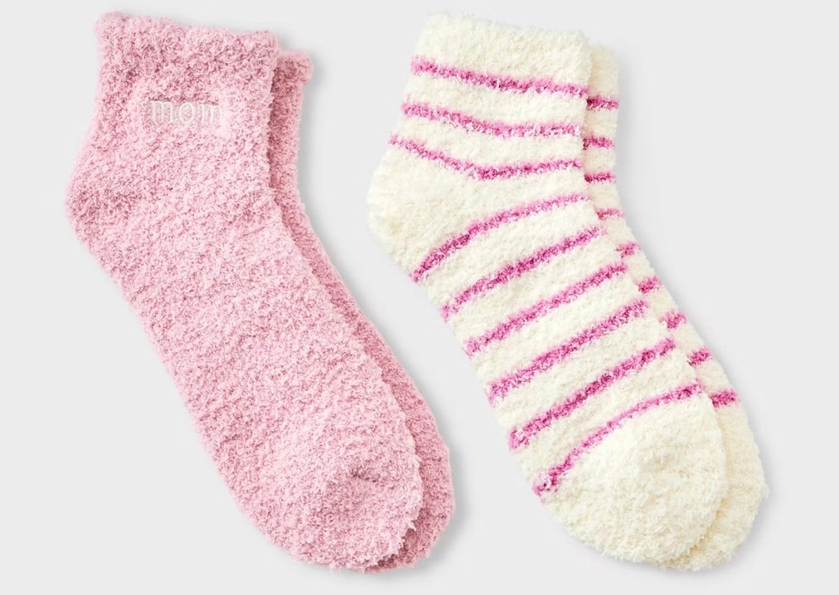 Two pairs of fuzzy socks make perfect Mother's Day gifts: one is solid pink with "mom" embroidered near the top, while the other features white and pink horizontal stripes. Both look irresistibly soft and cozy.