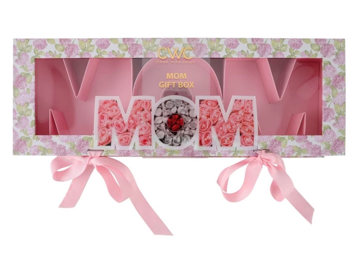 Rectangular floral gift box with “MOM” in large letters, some filled with pink and white artificial roses. It has two pink ribbon bows and a transparent window—perfect for showcasing flowers inside as thoughtful Mother's Day gifts.