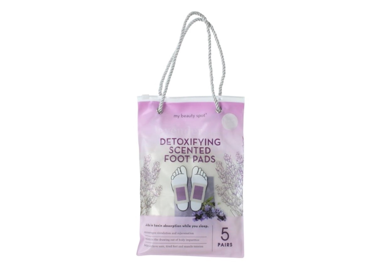 A pink and white package labeled "Detoxifying Scented Foot Pads," featuring two feet, lavender sprigs, a rope handle, and text indicating 5 pairs—available at Five Below.