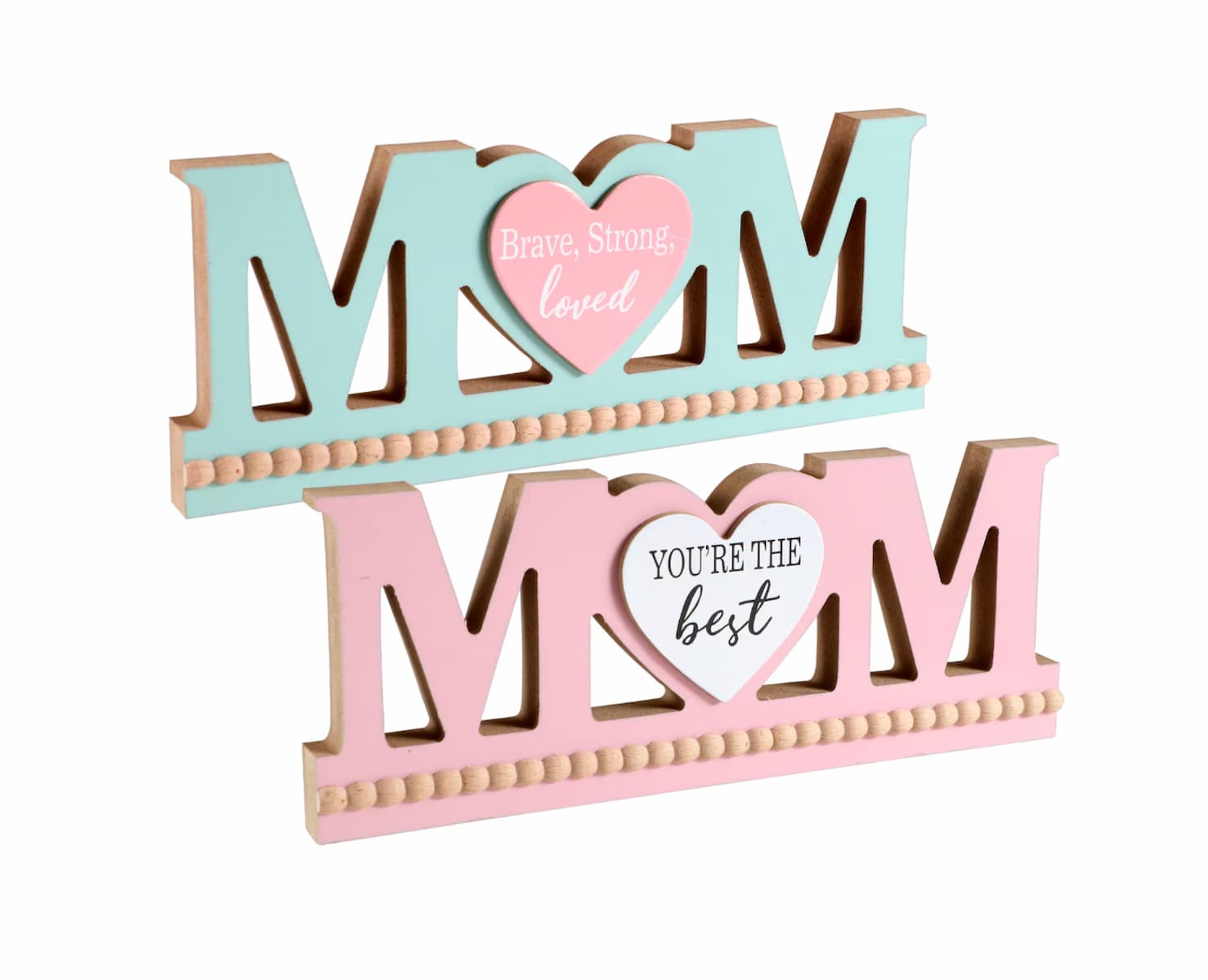 Two decorative wooden signs spelling "MOM" with heart shapes in the center. The top sign is aqua and pink, reading "Brave, Strong, loved." The bottom sign is pink and white, reading "YOU'RE THE best.