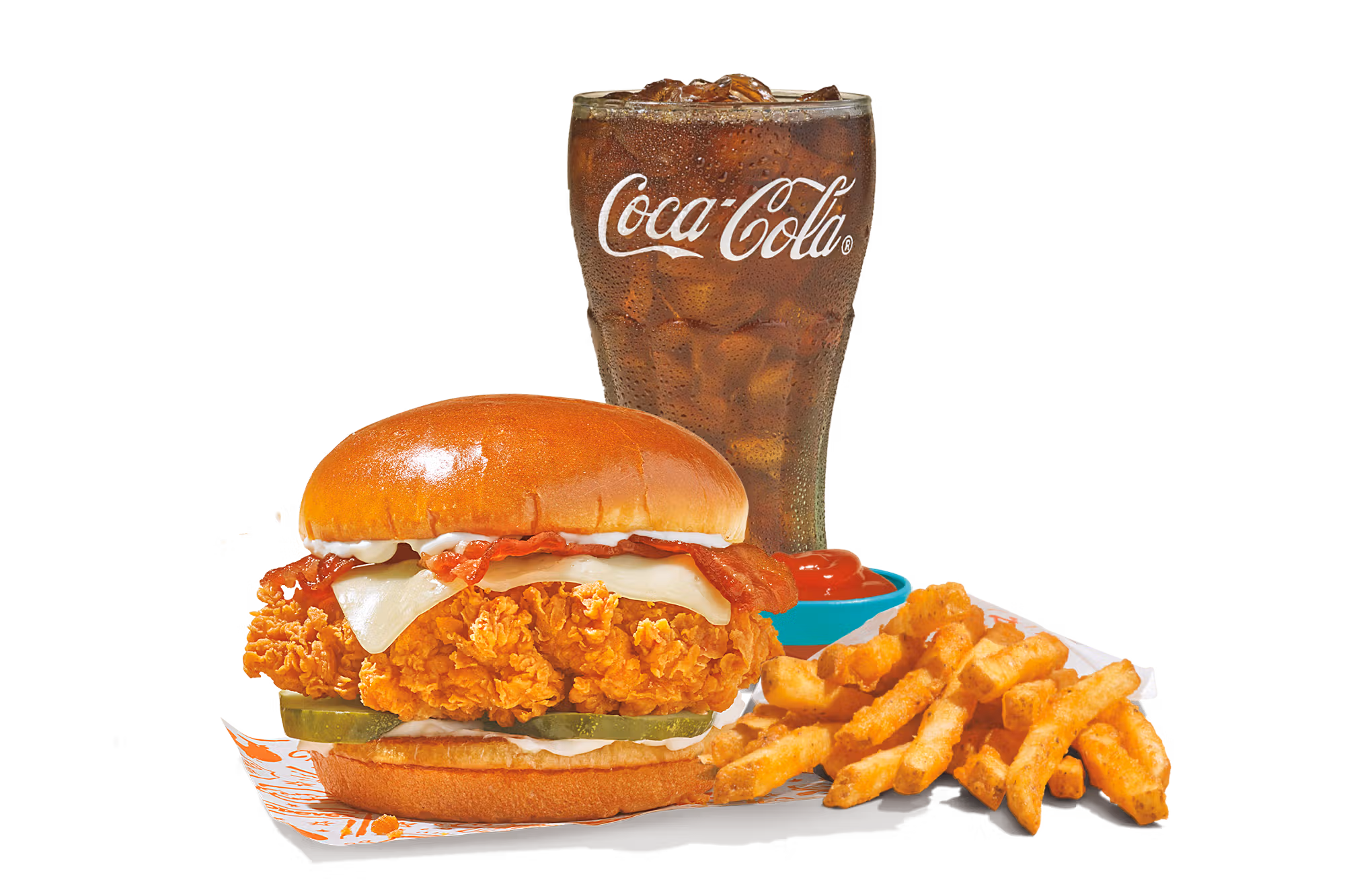 A crispy Chicken Sandwich with pickles, cheese, and bacon on a bun, served alongside crinkle-cut fries, ketchup, and a refreshing glass of Coca-Cola on a white background.