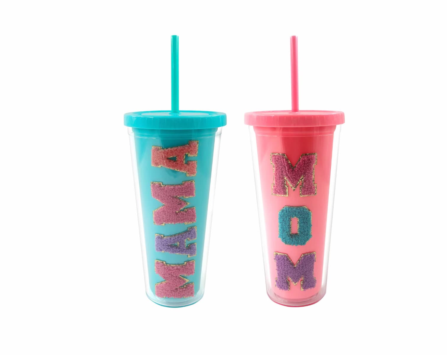 Two tall tumblers with straws, one teal with “MAMA” in colorful fuzzy letters and one pink with “MOM” in similar letters, standing side by side against a white background.