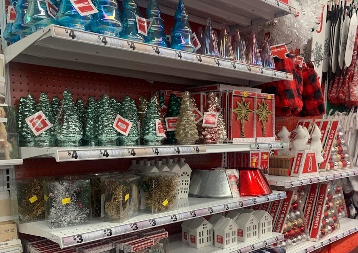 Store shelves at Five Below display various Christmas decorations, including mini Christmas trees, shiny cones, gift boxes, and red ornaments—all priced around $4—making it the perfect stop for your first time at Five Below.