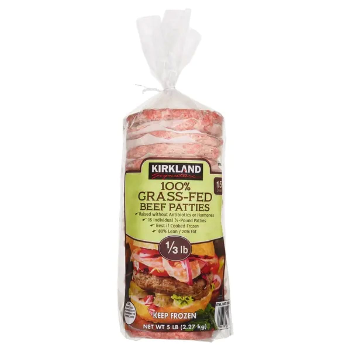 A package of Kirkland 100% Grass-Fed Beef Patties, showing frozen beef patties stacked inside a clear bag. The label highlights "no antibiotics or hormones" and "1/3 lb patties". Net weight is 5 lb.