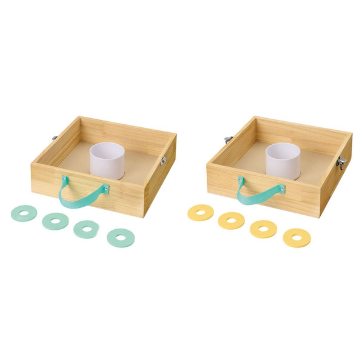Two wooden box games, each with a central white cylinder and a blue handle, are shown side by side. Four green rings are placed in front of the left box, and four yellow rings are in front of the right box.