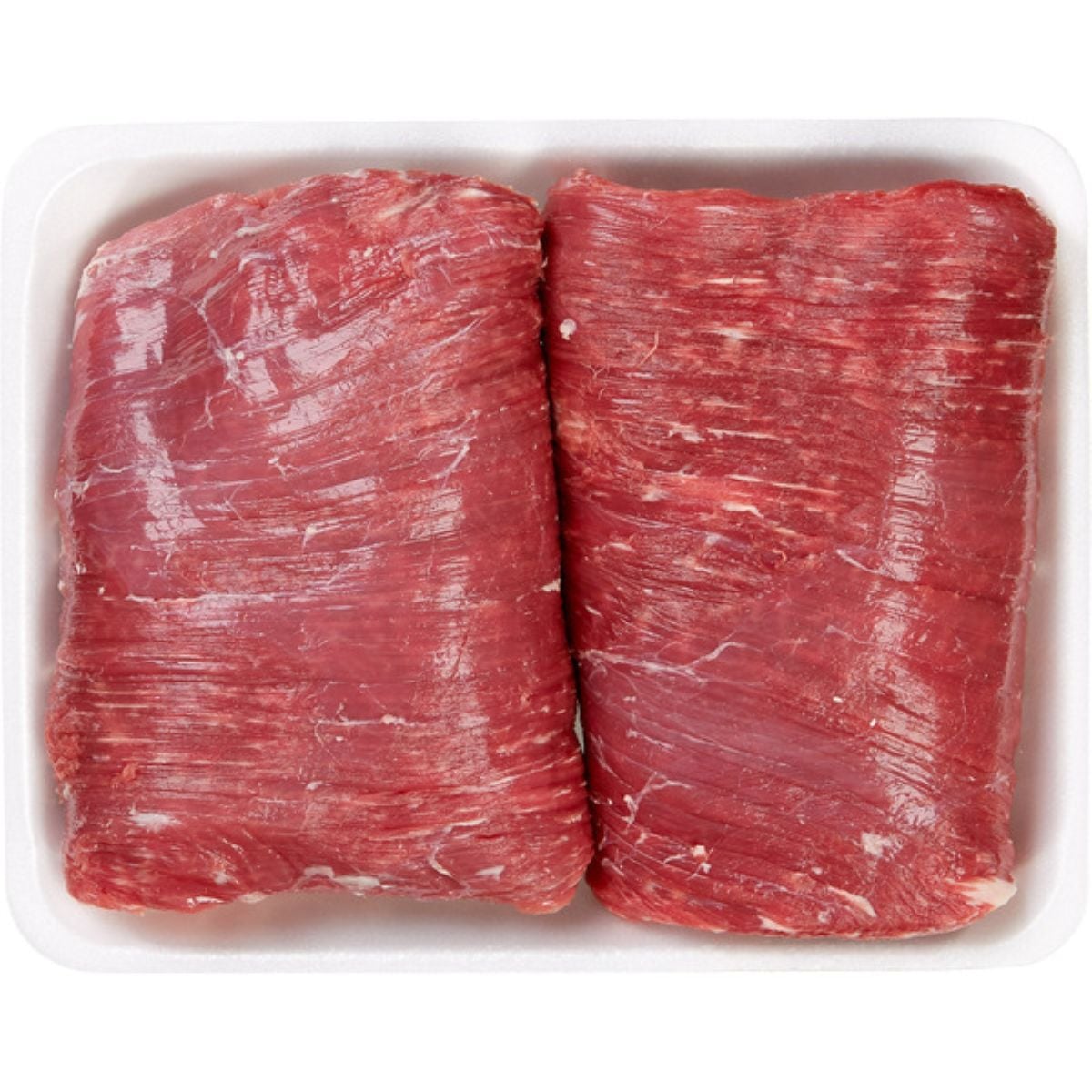 Two raw pieces of beef skirt steak placed side by side on a white foam tray, showing visible grain and marbling.