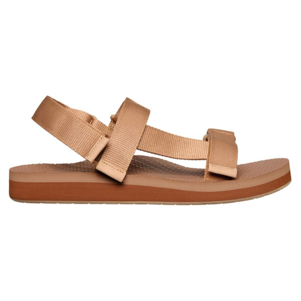 Tan-colored sandal with a flat sole and adjustable fabric straps, including one over the toes, one around the ankle, and one at the heel. The sandal has a textured footbed and a simple, minimalist design.